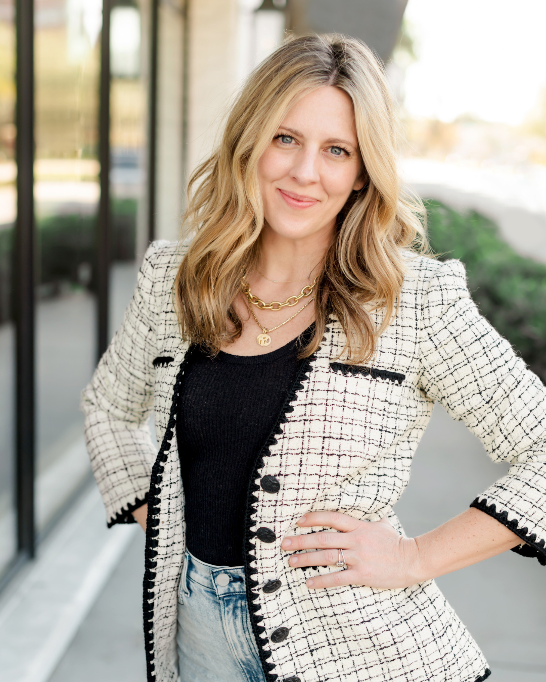 photo of women's bio  image wearing black top and checked blazer.