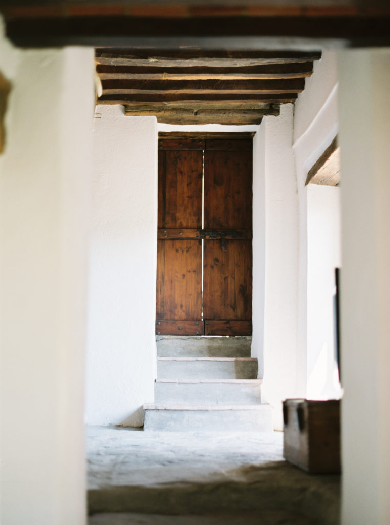 old wooden doors at the end of a path. An organic and textured setting.